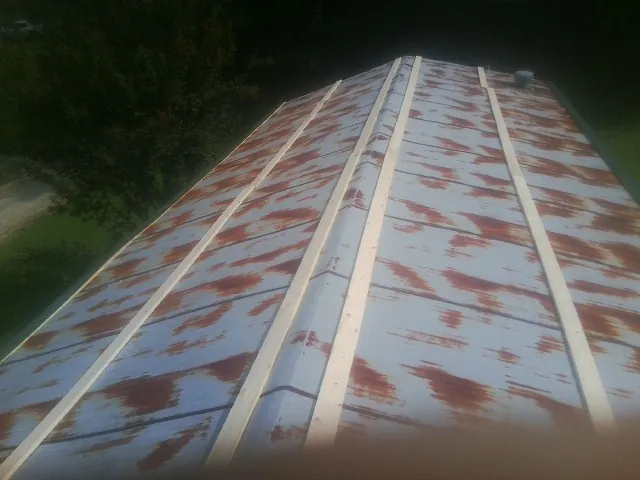 Rusted metal roof panels with new wood purlins before replacement — Storm Damage Roof Repair in Aynor by Roofing Brothers