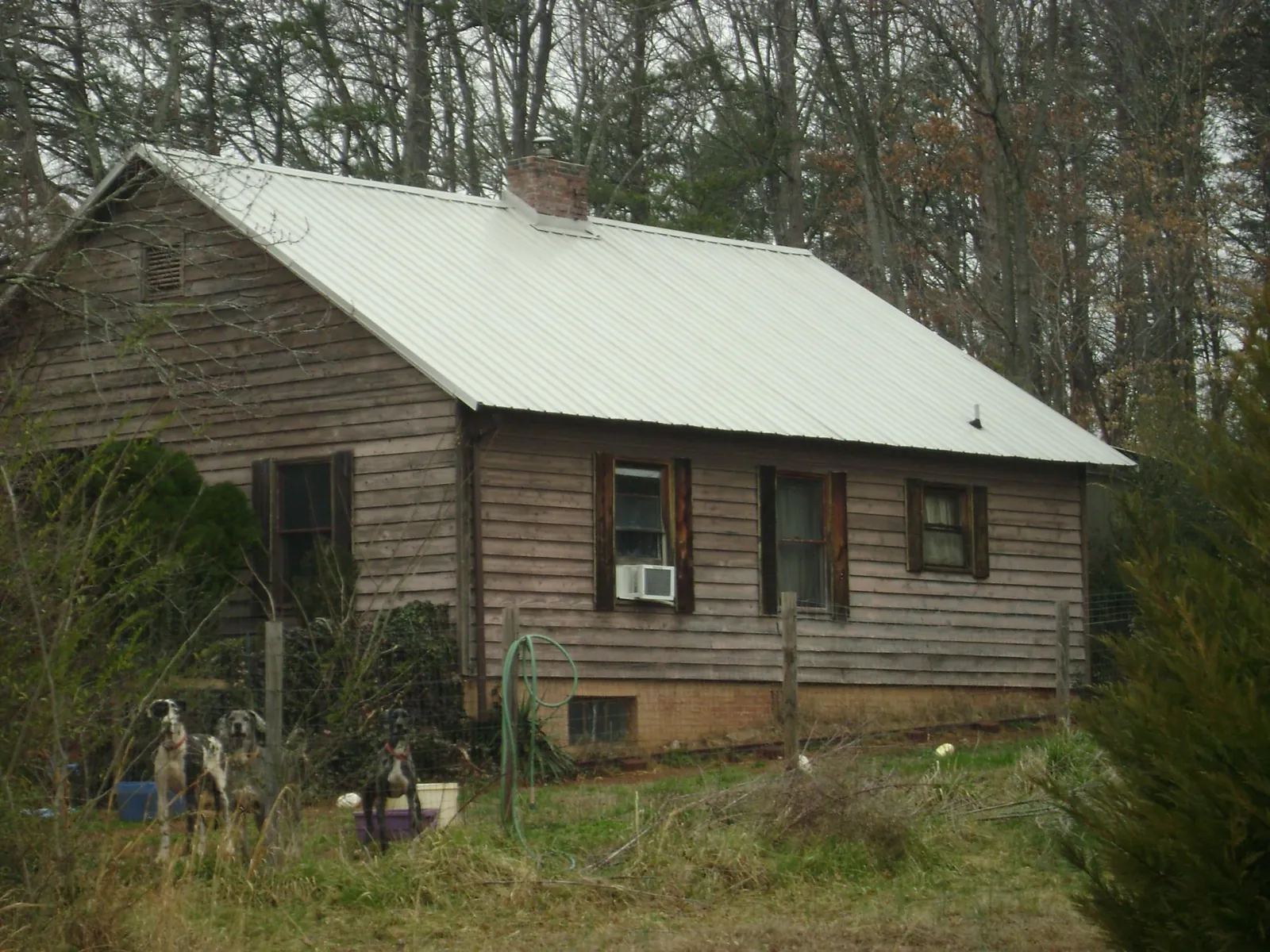 White metal roof on an old wood sided farmhouse, from a Metal Roof Installation job in Aynor